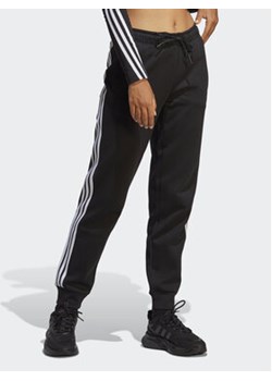 adidas Spodnie dresowe Future Icons 3-Stripes Regular Tracksuit Bottoms HT4704 Czarny Regular Fit ze sklepu MODIVO w kategorii Spodnie damskie - zdjęcie 168635884