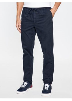 Tommy Hilfiger Spodnie materiałowe MW0MW32131 Granatowy Regular Fit ze sklepu MODIVO w kategorii Spodnie męskie - zdjęcie 168636203