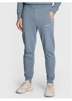 Calvin Klein Spodnie dresowe Micro Logo K10K109940 Szary Relaxed Fit ze sklepu MODIVO w kategorii Spodnie męskie - zdjęcie 168638442