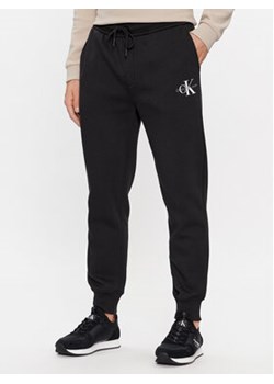 Calvin Klein Jeans Spodnie dresowe Monologo J30J324685 Czarny Regular Fit ze sklepu MODIVO w kategorii Spodnie męskie - zdjęcie 168645693