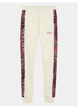 Guess Spodnie dresowe J3BQ18 KAX73 Écru Regular Fit ze sklepu MODIVO w kategorii Spodnie dziewczęce - zdjęcie 168654643