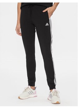 adidas Spodnie dresowe 3-Stripes GM5542 Czarny Slim Fit ze sklepu MODIVO w kategorii Spodnie damskie - zdjęcie 168654934