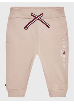 Tommy Hilfiger Spodnie dresowe Essential KN0KN01281 Beżowy Regular Fit ze sklepu MODIVO w kategorii Spodnie i półśpiochy - zdjęcie 168679842