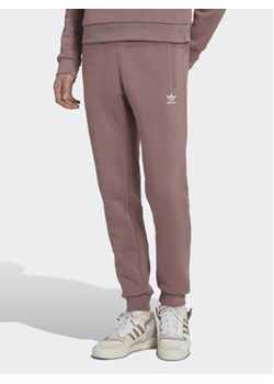 adidas Spodnie dresowe adicolor Essentials Trefoil HK0105 Różowy Slim Fit ze sklepu MODIVO w kategorii Spodnie damskie - zdjęcie 168787880