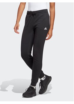 adidas Spodnie dresowe Essentials Linear French Terry Cuffed Joggers IC6868 Czarny Slim Fit ze sklepu MODIVO w kategorii Spodnie damskie - zdjęcie 169340993