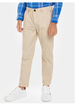 Tommy Hilfiger Spodnie materiałowe KB0KB08895 Beżowy Regular Fit ze sklepu MODIVO w kategorii Spodnie chłopięce - zdjęcie 169634773