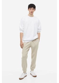 H & M - Spodnie dresowe Regular Fit - Brązowy ze sklepu H&M w kategorii Spodnie męskie - zdjęcie 169676733