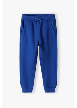 Niebieskie spodnie dresowe dla  dużego dziecka - unisex - Limited Edition ze sklepu 5.10.15 w kategorii Spodnie chłopięce - zdjęcie 169724074