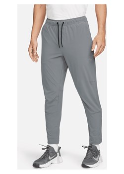Męskie uniwersalne spodnie ze ściągaczami i zamkami Dri-FIT Nike Unlimited - Szary ze sklepu Nike poland w kategorii Spodnie męskie - zdjęcie 169757342