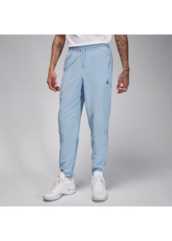 Męskie spodnie z tkaniny Jordan Dri-FIT Sport - Niebieski ze sklepu Nike poland w kategorii Spodnie męskie - zdjęcie 169759120