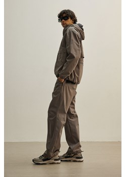 H & M - Spodnie przeciwdeszczowe StormMove Unisex - Beżowy ze sklepu H&M w kategorii Spodnie męskie - zdjęcie 170039754
