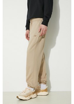 New Balance spodnie dresowe bawełniane MP41508SOT kolor beżowy gładkie ze sklepu PRM w kategorii Spodnie męskie - zdjęcie 170264251