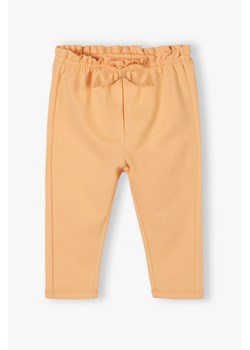 Pomarańczowe bawełniane spodnie niemowlęce z kokardką ze sklepu 5.10.15 w kategorii Spodnie i półśpiochy - zdjęcie 170405213