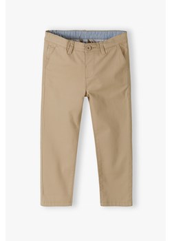 Beżowe spodnie dla chłopca - chinosy Max&Mia ze sklepu 5.10.15 w kategorii Spodnie chłopięce - zdjęcie 170431361