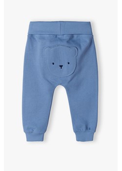 Ciepłe bawełniane spodnie niemowlęce z misiem - niebieskie ze sklepu 5.10.15 w kategorii Spodnie i półśpiochy - zdjęcie 170492841