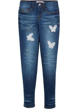Dżinsy dziewczęce z aplikacją w kształcie motyli ze sklepu bonprix w kategorii Spodnie dziewczęce - zdjęcie 170614981