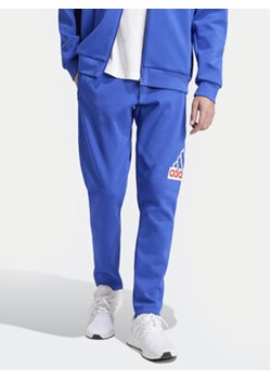 adidas Spodnie dresowe Future Icons Badge of Sport IS9594 Niebieski Regular Fit ze sklepu MODIVO w kategorii Spodnie męskie - zdjęcie 170942444
