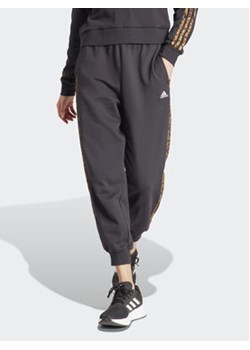 adidas Spodnie dresowe Essentials 3-Stripes IS2155 Czarny Loose Fit ze sklepu MODIVO w kategorii Spodnie damskie - zdjęcie 171212351