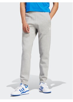 adidas Spodnie dresowe Trefoil Essentials IR7803 Szary Slim Fit ze sklepu MODIVO w kategorii Spodnie męskie - zdjęcie 171212741
