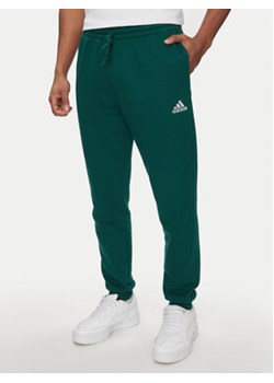 adidas Spodnie dresowe Essentials IJ8892 Zielony Regular Fit ze sklepu MODIVO w kategorii Spodnie męskie - zdjęcie 171344322