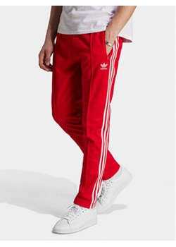 adidas Spodnie dresowe adicolor Classics Beckenbauer IM4547 Czerwony Slim Fit ze sklepu MODIVO w kategorii Spodnie męskie - zdjęcie 171449102