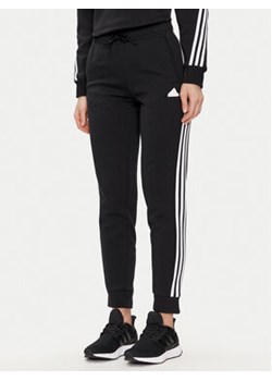 adidas Spodnie dresowe Future Icons 3-Stripes IN9479 Czarny Regular Fit ze sklepu MODIVO w kategorii Spodnie damskie - zdjęcie 171537832