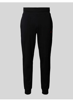 Spodnie dresowe o luźnym kroju z nadrukiem z logo model ‘Linked’ ze sklepu Peek&Cloppenburg  w kategorii Spodnie męskie - zdjęcie 172183131
