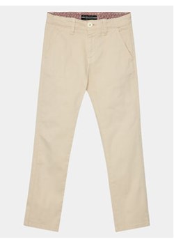 Guess Spodnie materiałowe Chino L3BB00 WFPMA Beżowy Regular Fit ze sklepu MODIVO w kategorii Spodnie chłopięce - zdjęcie 172397431