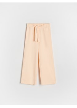 Reserved - Bawełniane spodnie - jasnopomarańczowy ze sklepu Reserved w kategorii Spodnie dziewczęce - zdjęcie 172530153