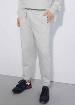 Kremowe spodnie dresowe męskie ze sklepu OCHNIK w kategorii Spodnie męskie - zdjęcie 172559523