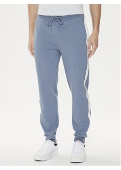 Tommy Hilfiger Spodnie dresowe UM0UM03013 Niebieski Regular Fit ze sklepu MODIVO w kategorii Spodnie męskie - zdjęcie 172598183