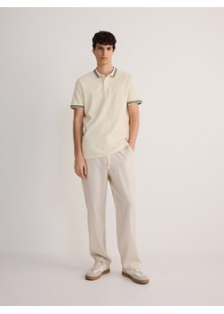 Reserved - Spodnie loose fit z lyocellu - złamana biel ze sklepu Reserved w kategorii Spodnie męskie - zdjęcie 173381471