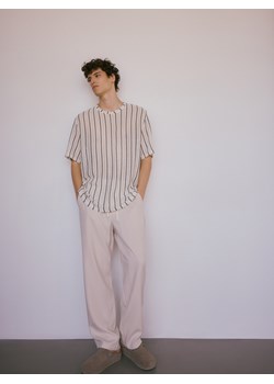 Reserved - Spodnie loose fit z lyocellu - złamana biel ze sklepu Reserved w kategorii Spodnie męskie - zdjęcie 173406470