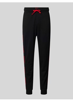 Spodnie dresowe z detalami z logo model ‘Sporty’ ze sklepu Peek&Cloppenburg  w kategorii Spodnie męskie - zdjęcie 173554372