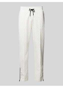 Spodnie dresowe z nadrukiem z logo na całej powierzchni model ‘KORBIN’ ze sklepu Peek&Cloppenburg  w kategorii Spodnie męskie - zdjęcie 173677110
