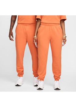 Spodnie dresowe NOCTA Fleece CS - Pomarańczowy ze sklepu Nike poland w kategorii Spodnie męskie - zdjęcie 173739171