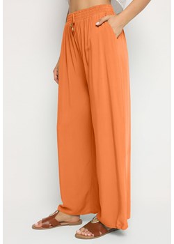 Pomarańczowe Gładkie Spodnie z Gumką w Pasie i Szerokimi Nogawkami Alathera ze sklepu Born2be Odzież w kategorii Spodnie damskie - zdjęcie 173829784