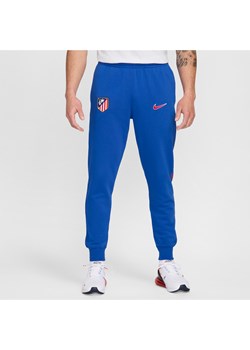 Męskie joggery piłkarskie z dzianiny dresowej Nike Atlético Madryt Club (wersja domowa) - Niebieski ze sklepu Nike poland w kategorii Spodnie męskie - zdjęcie 174117884