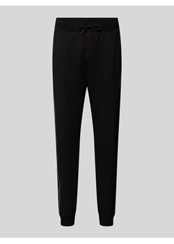 Spodnie dresowe o kroju regular fit z nadrukiem z logo model ‘MICKEY’ ze sklepu Peek&Cloppenburg  w kategorii Spodnie męskie - zdjęcie 174128460
