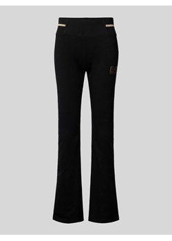 Spodnie materiałowe z poszerzaną nogawką i nadrukiem z logo model ‘TRAIN CORE LADY’ ze sklepu Peek&Cloppenburg  w kategorii Spodnie damskie - zdjęcie 174557201
