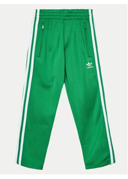 adidas Spodnie dresowe Firebird IY9804 Zielony Regular Fit ze sklepu MODIVO w kategorii Spodnie chłopięce - zdjęcie 176657873