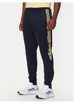 adidas Spodnie dresowe Tiro Wordmark IW5997 Granatowy Regular Fit ze sklepu MODIVO w kategorii Spodnie męskie - zdjęcie 176993151