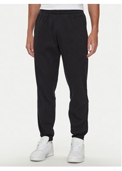 adidas Spodnie dresowe Trefoil Essentials IW5805 Czarny Regular Fit ze sklepu MODIVO w kategorii Spodnie męskie - zdjęcie 177240322