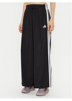 adidas Spodnie dresowe Essentials 3-Stripes JE1306 Czarny Loose Fit ze sklepu MODIVO w kategorii Spodnie damskie - zdjęcie 177597430