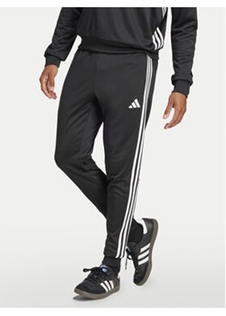 adidas Spodnie dresowe Tiro 25 Essentials Sweat JC5464 Czarny Regular Fit ze sklepu MODIVO w kategorii Spodnie męskie - zdjęcie 178237253