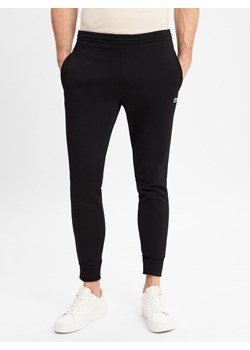 Lacoste Spodnie dresowe Mężczyźni czarny jednolity - id: 567315-0006-09940 - marki Lacoste - 178349101 Lacoste Spodnie dresowe Mężczyźni czarny jednolity ze sklepu vangraaf w kategorii Spodnie męskie - zdjęcie 178349101