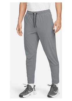 Męskie uniwersalne spodnie ze ściągaczami i zamkami Dri-FIT Nike Unlimited - Szary ze sklepu Nike poland w kategorii Spodnie męskie - zdjęcie 178606923