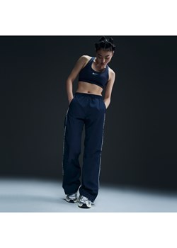 Damskie spodnie z tkaniny z wysokim stanem i luźnymi nogawkami Nike Windrunner - Niebieski ze sklepu Nike poland w kategorii Spodnie damskie - zdjęcie 178609512