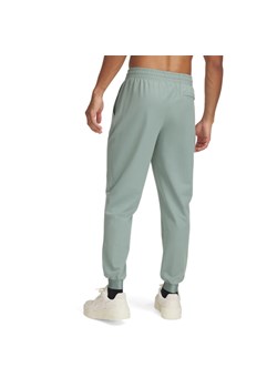 Męskie spodnie treningowe Under Armour UA Unstoppable Joggers - zielone ze sklepu Sportstylestory.com w kategorii Spodnie męskie - zdjęcie 179003132