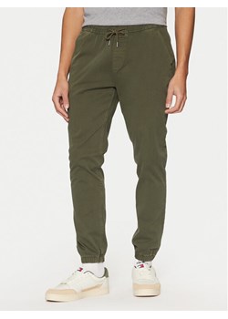 Tommy Jeans Joggery Austin DM0DM20283 Zielony Slim Fit ze sklepu MODIVO w kategorii Spodnie męskie - zdjęcie 181043353